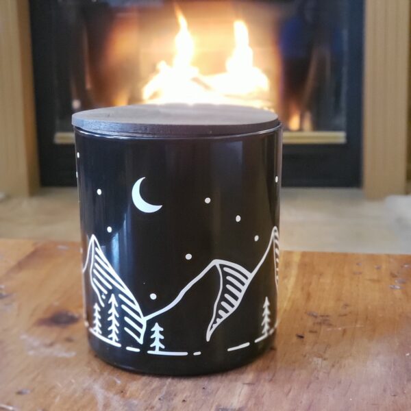 Vela’s glowing Campfire Candle is scented with fir and cedar and fitted