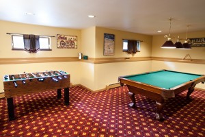 Game room with pool table, foosball, exercise bike, and workout equipment